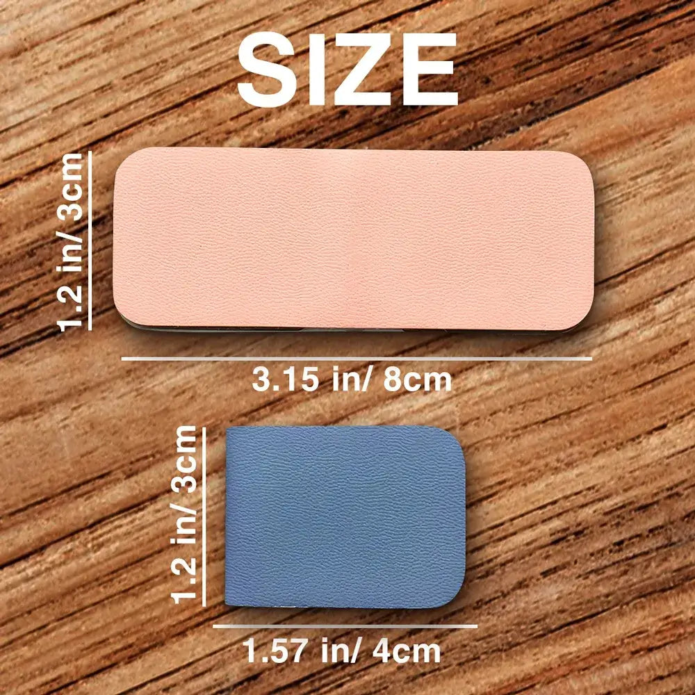 Two patches, one pink and one blue, with measurements on a wooden surface.