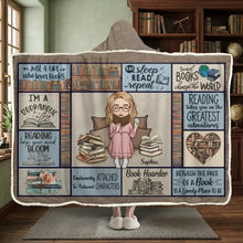 A young woman reading a novel wearing a custom snuggle hoodie blanket