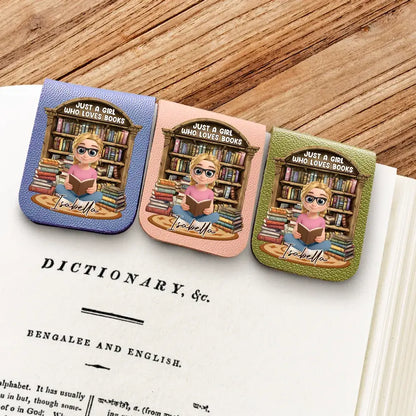 Three colorful personalized custom leather bookmark with cartoon character design on a book