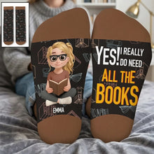 Woman resting her feet on a bed wearing custom crew socks.