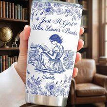 Woman reading a classic novel holding her personalized tumbler cup