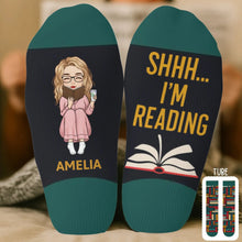 Woman reading a novel wearing custom crew socks.