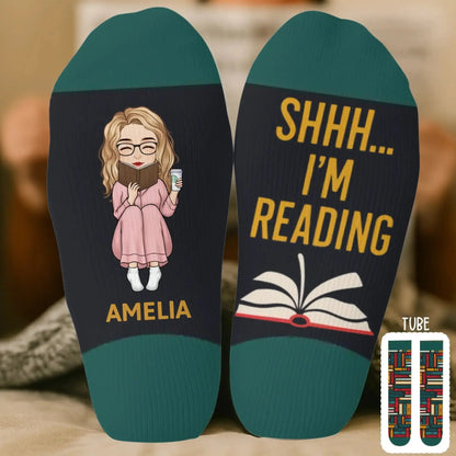 Woman reading a novel wearing custom crew socks.