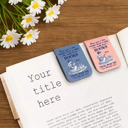 Two beautiful personalized aesthetic reading bookmarks on an open book with flowers on a wooden surface