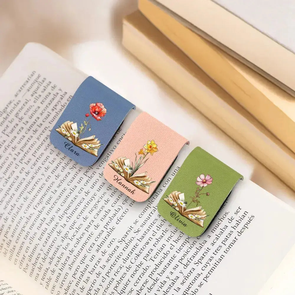 Three beautiful birth month flower bookmarks for readers resting on a book