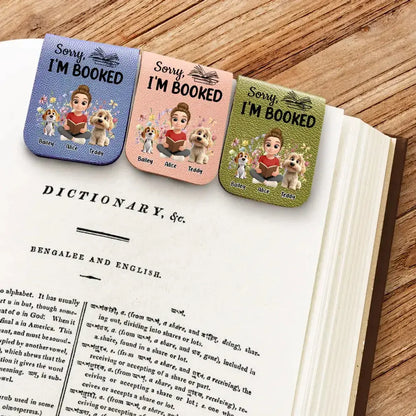 Three beautiful custom pet portrait bookmarks for readers resting on a novel