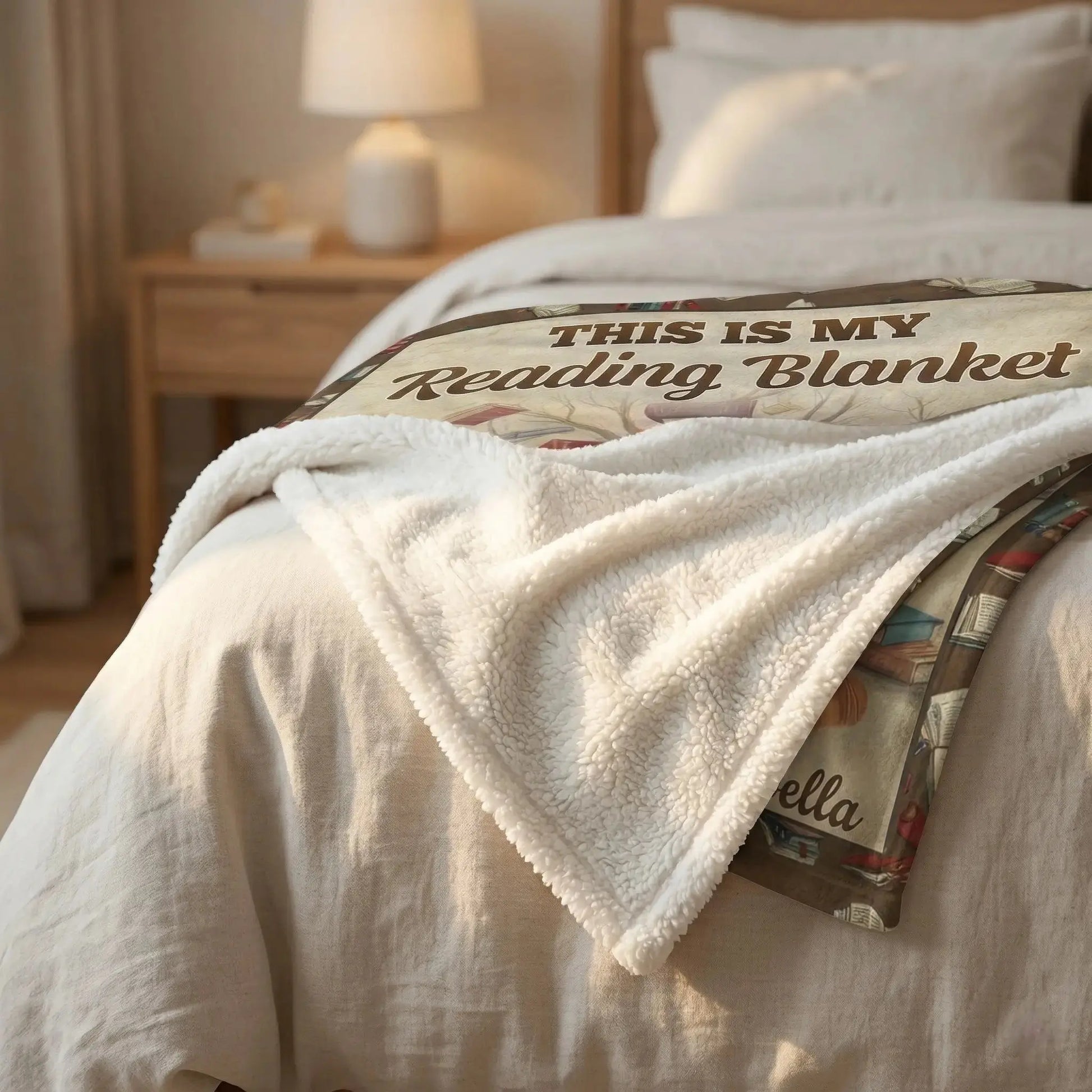 Folded personalized blanket for book lovers resting on a bed