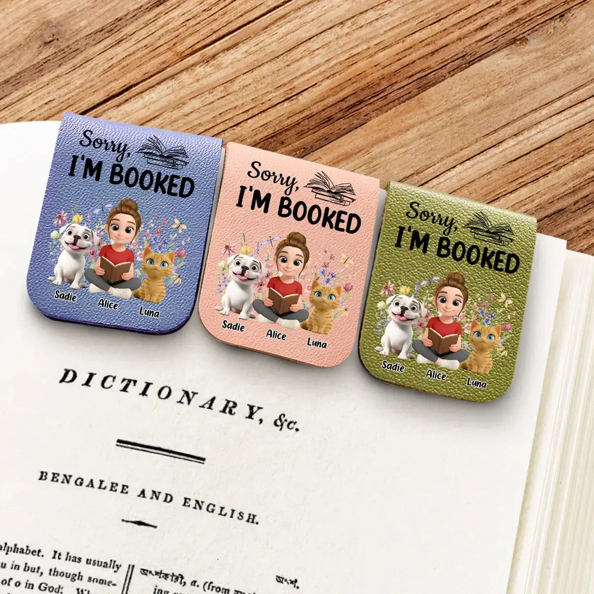 Flat lay of book lover gifts with dog cat illustrations on a desk.