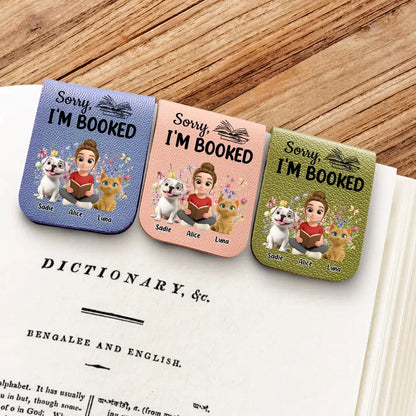 Flat lay of book lover gifts with dog cat illustrations on a desk.