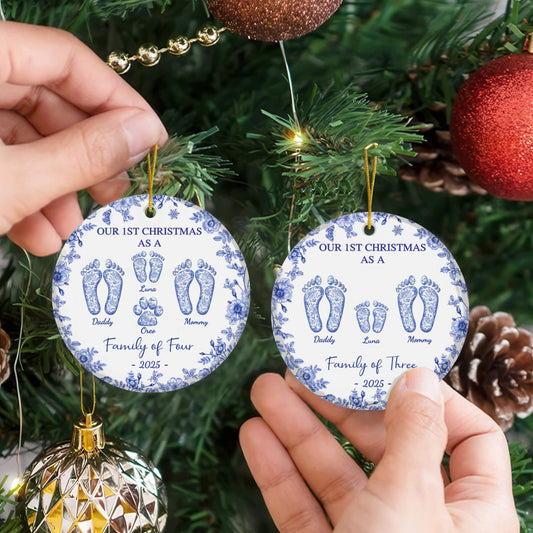 Two round custom ceramic ornaments with blue floral borders, personalized footprints and family names, 2025 Christmas.