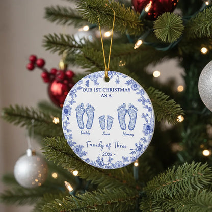 Round ceramic ornament with blue floral border and footprints for Daddy, Luna, Mommy - Family of Three, 2025.
