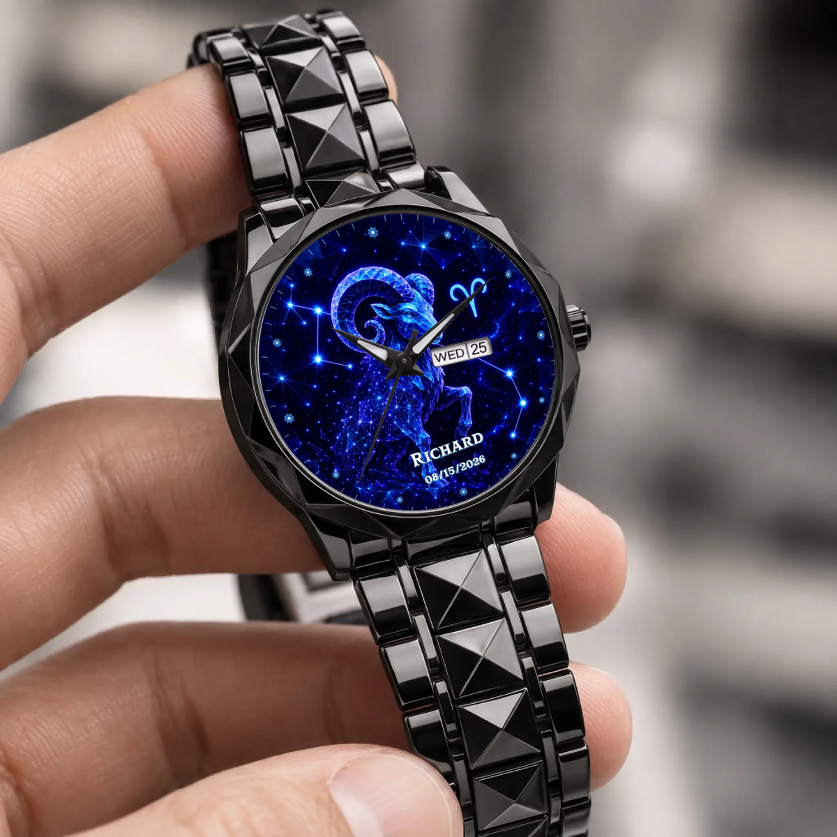 Personalized zodiac watch - black faceted bracelet held in a hand