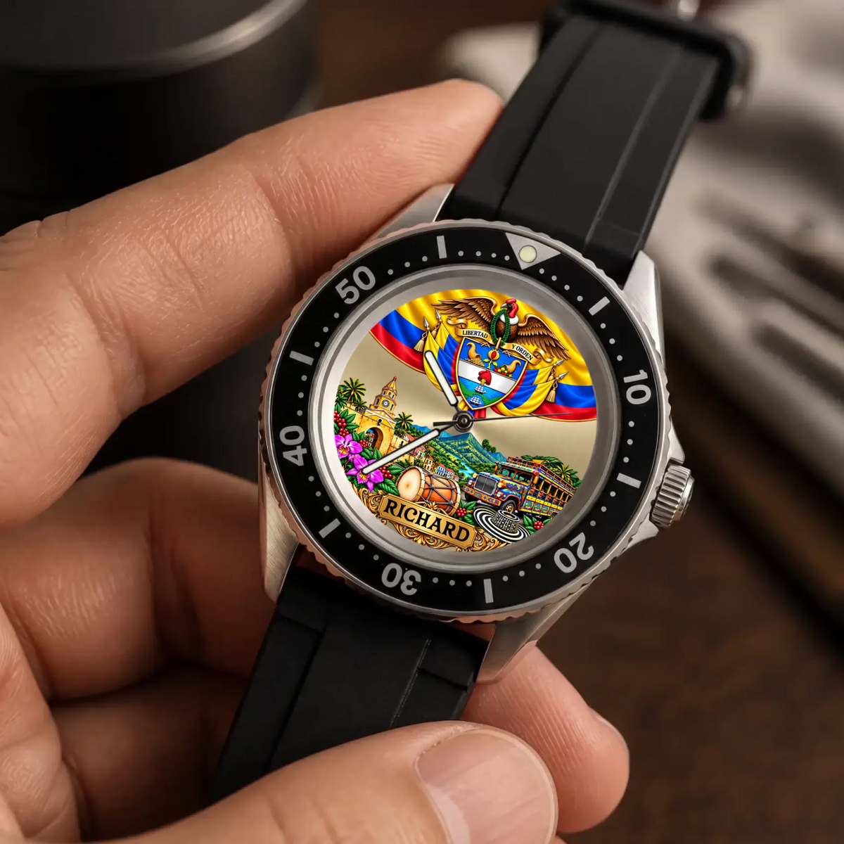 Personalized Colombian watch with custom name, Rift Diver style with black strap held against a dark background