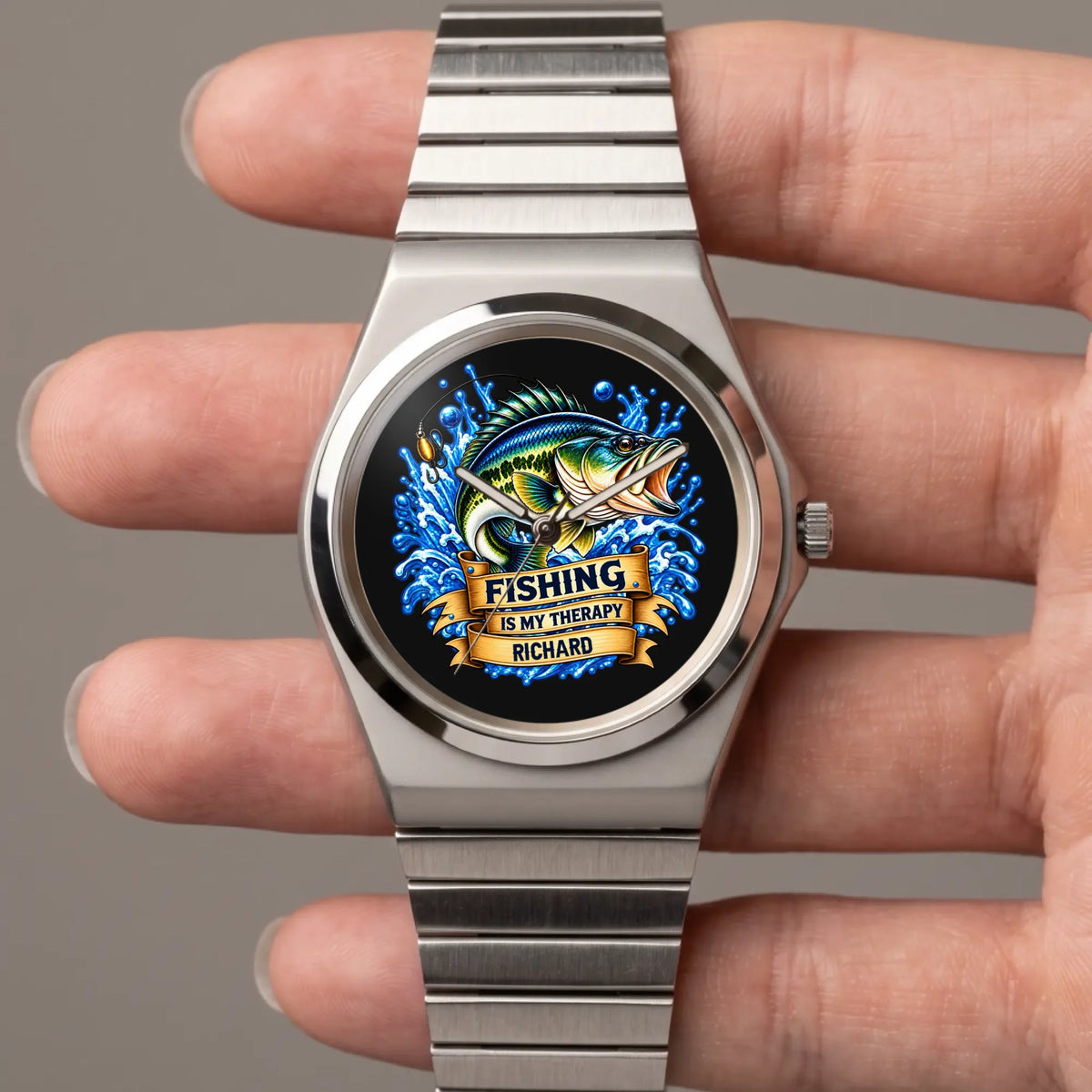 Hand-held close-up of the Signature Round personalized fishing watch with blue fish artwork