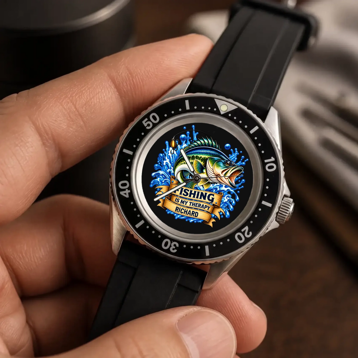 Angled hand-held close-up of the RIFT DIVER custom name fishing watch and numbered bezel