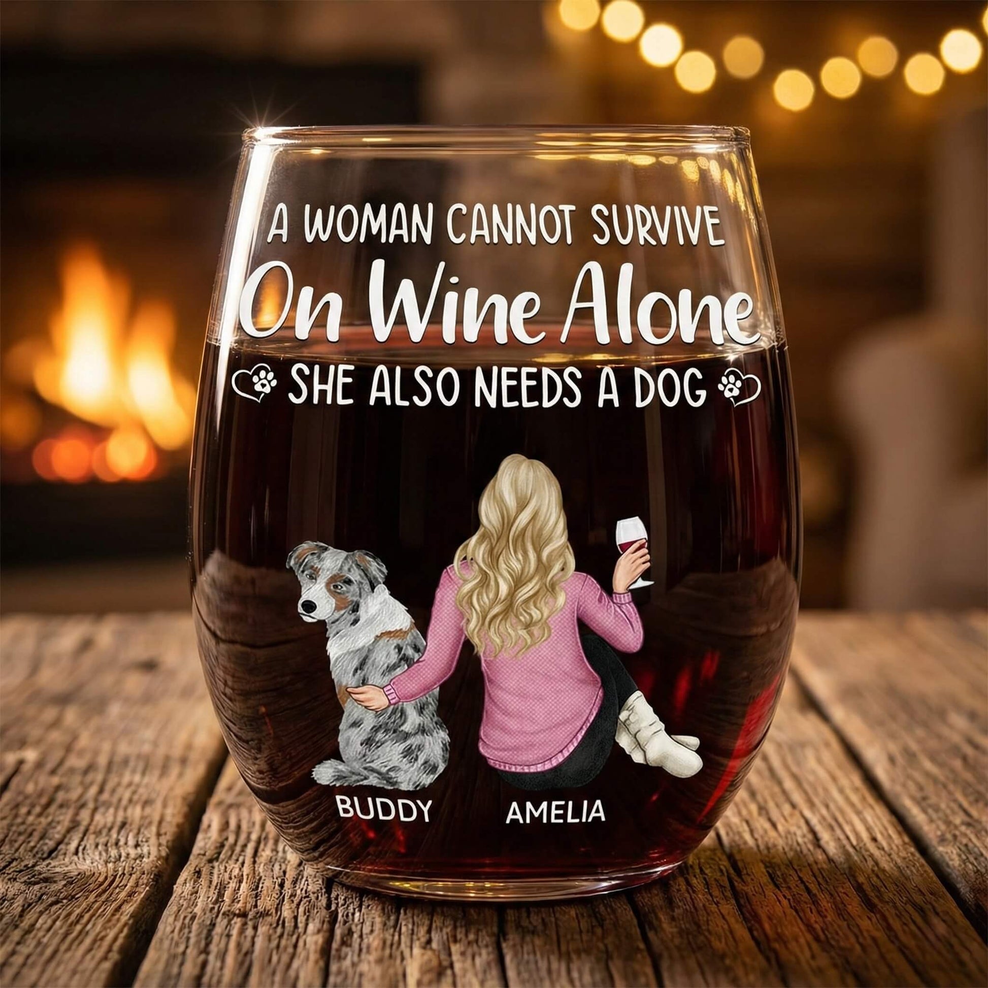 Personalized wine glasses with a design of a woman, dog, and text about wine and dogs, placed on a wooden surface with a warm background.