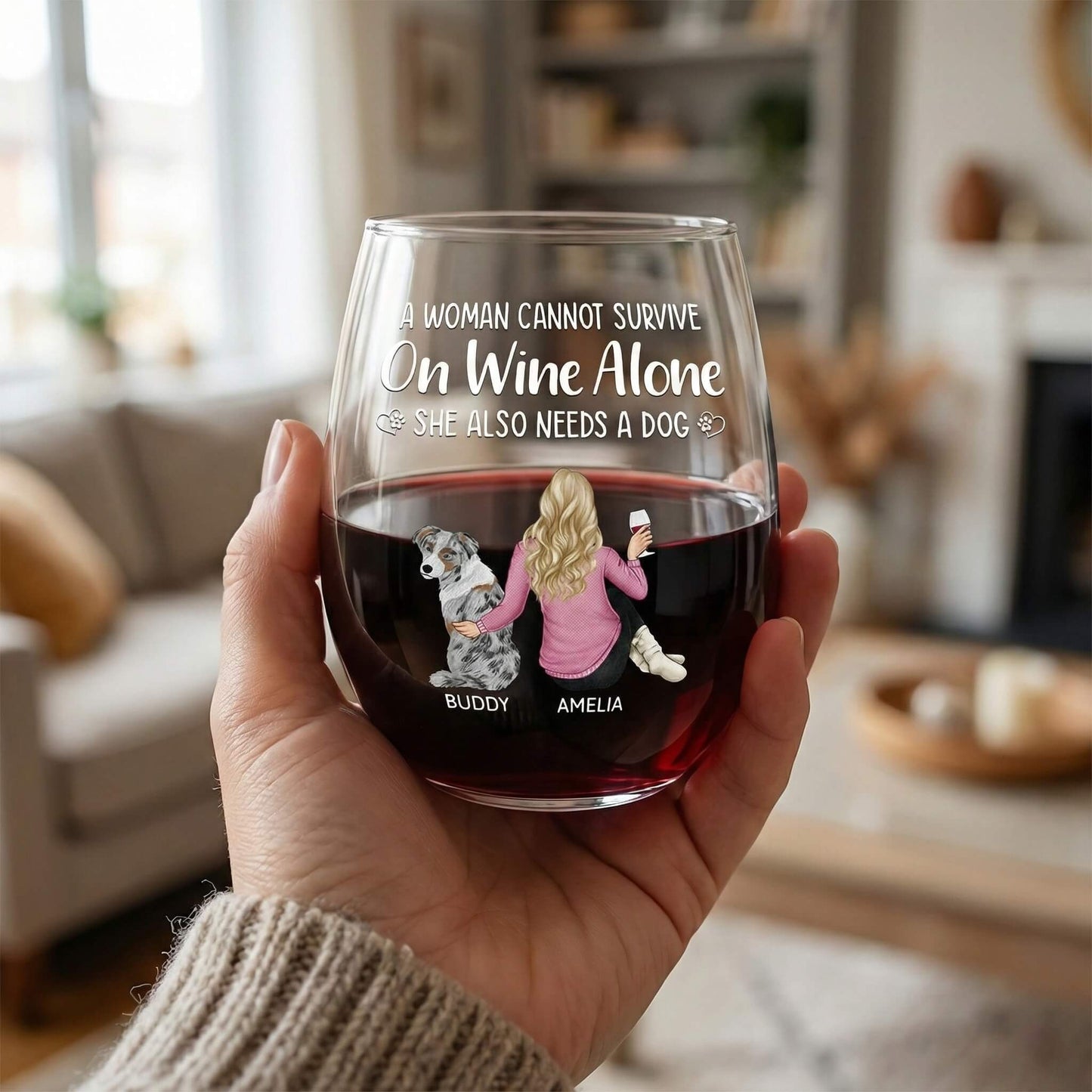 Woman holding personalized wine glasses with custom dog illustration.