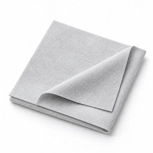 Light gray watch care cloth folded on a white background