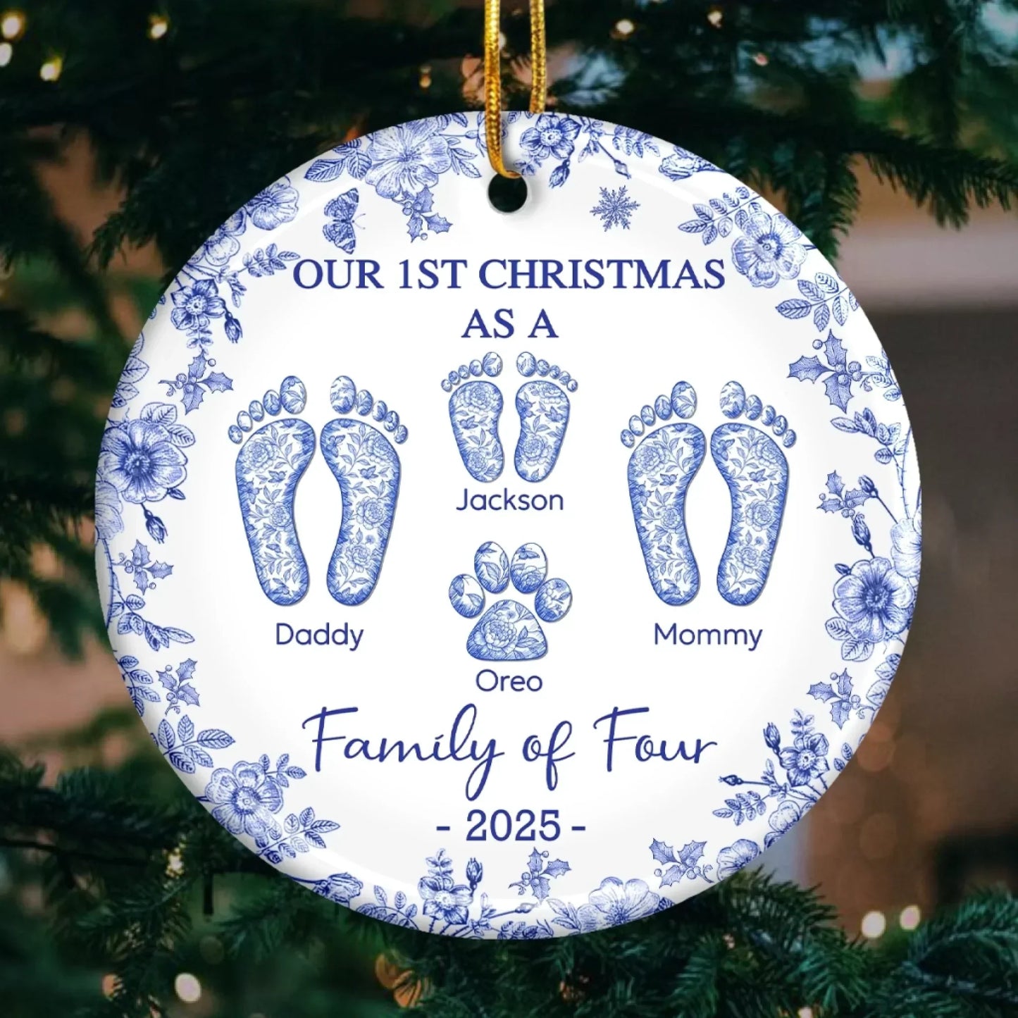 Round ceramic ornament with blue floral border; footprints labeled Daddy, Mommy, Jackson, Oreo; Family of Four, 2025.