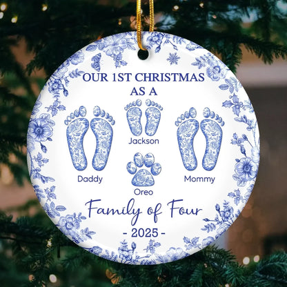 Round ceramic ornament with blue floral border; footprints labeled Daddy, Mommy, Jackson, Oreo; Family of Four, 2025.